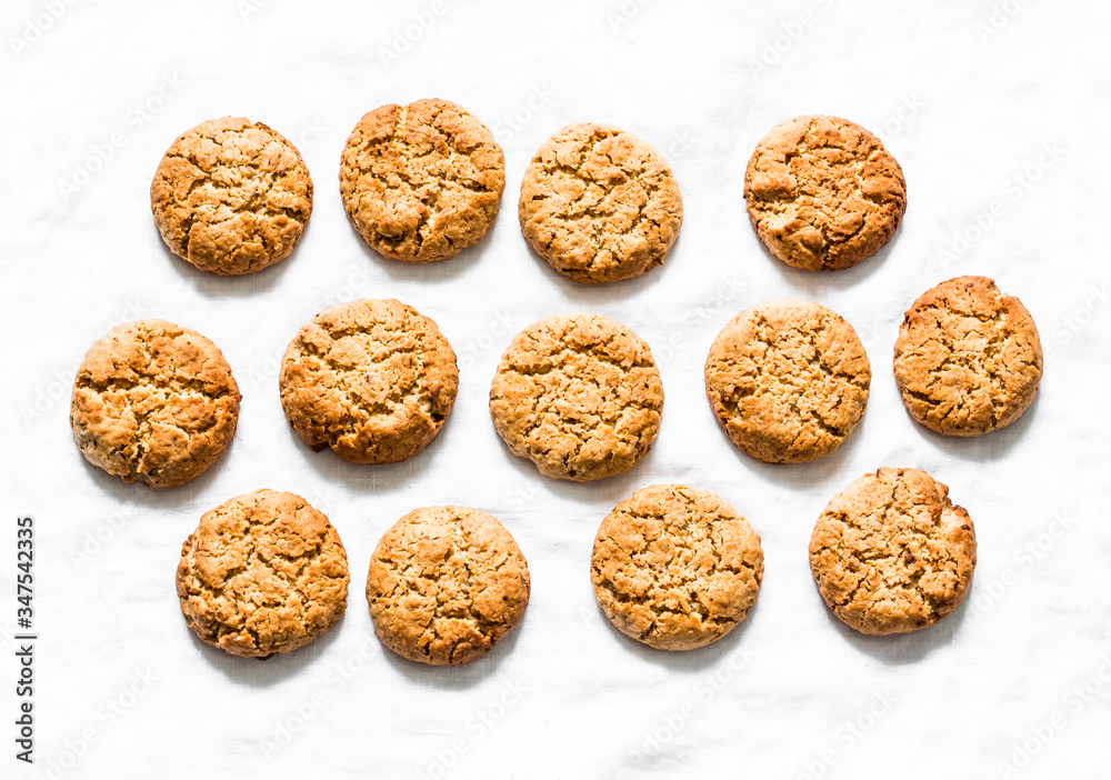 Delicious oatmeal gluten free cookies with walnuts on a light background, top view