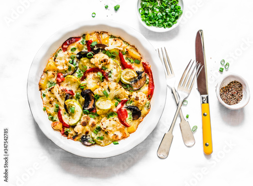 Baked vegetables frittata - delicious appetizer, tapas, snack, breakfast on a light background, top view