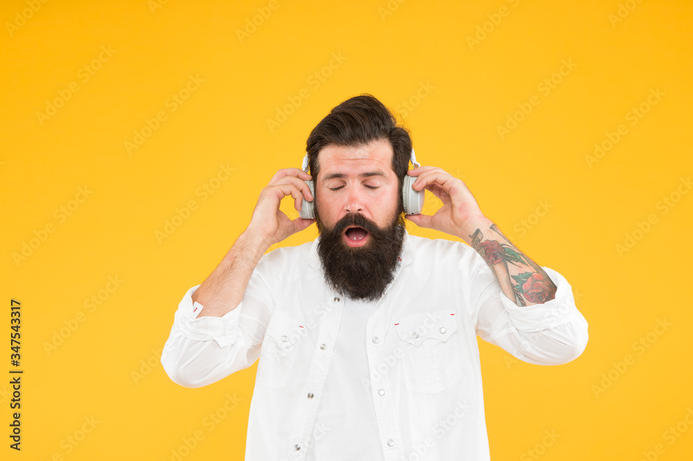Hearing problem. Bearded man headphones. Modern wireless headphones. Dance music tracks. Ears health. Loud music. Active Noise Cancellation Technology. Hipster listen music stereo headphones Hearing problem. Bearded man headphones. Modern wireless headphones. Dance music tracks. Ears health. Loud music. Active Noise Cancellation Technology. Hipster listen music stereo headphones