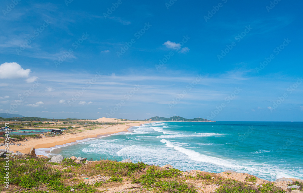 Expansive view of scenic tropical bay, Bai Mon gorgeous golden beach sand dunes blue waving sea. The easternmost coast in Vietnam, Phu Yen province between Da Nang and Nha Trang.