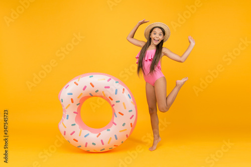 Getting golden tan. little girl going to play in water. having fun on the beach. happy kid on summer beach. Relax in Sea. having fun in waterpark. Girl with inflatable rubber ring at swimming pool