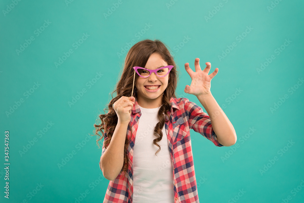 Fototapeta premium childhood happiness. child in good and positive mood. looking smart in glasses. aggressive small girl prefect casual fashion. happy kid in funny party glasses. school girl having fun