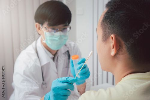 Konstfotografi Doctor or medical staff is collecting secretions from patient for examination in the lab