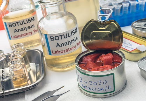 Experienced laboratory scientist analyzes red peppers from a canned food can to analyze botulism infection in sick people, conceptual image photo