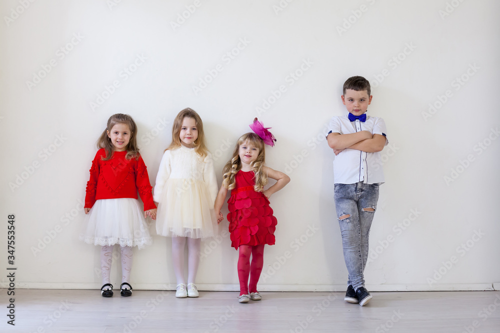 Fototapeta premium three girls and boy friends in a white room