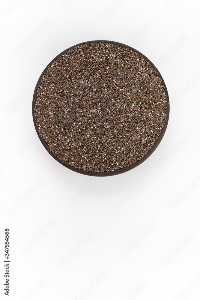 Chia seeds in round bowl on white background, top view Chia seeds in round bowl on white background, top view