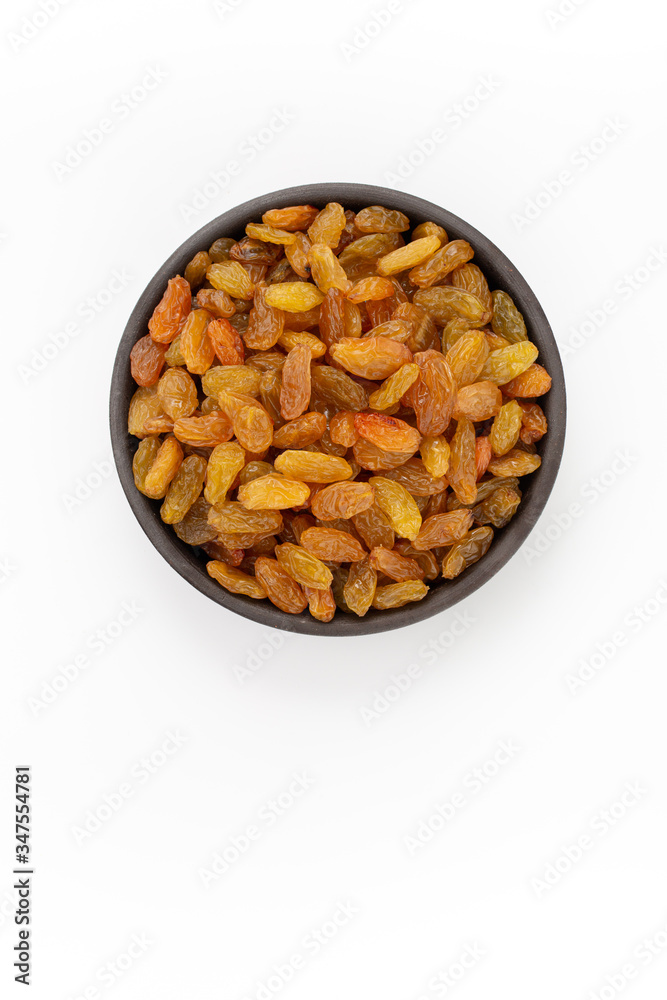 Golden raisins in round bowl on white background, top view Golden raisins in round bowl on white background, top view