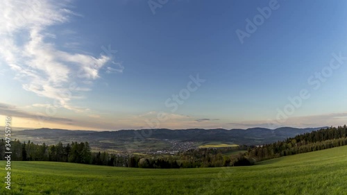Wallpaper Mural Orange timelapse sunset over a village lying in middle a valley surrounded by lots of mountains hills during a spring sunny day full of clouds moving sky overlooking farms surroundings village Zasova Torontodigital.ca