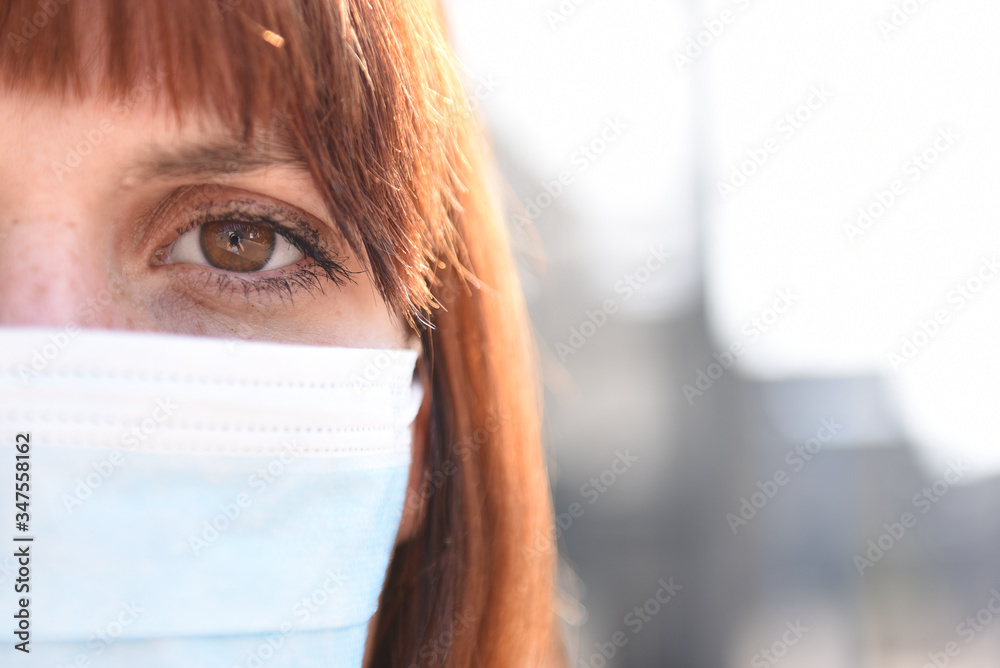 Girl in protective mask on the background of the deserted city. Post-apocalypse survival after the covid-19 coronavirus pandemic. World after global catastrophe. Girl in protective mask on the background of the deserted city. Post-apocalypse survival after the covid-19 coronavirus pandemic. World after global catastrophe.