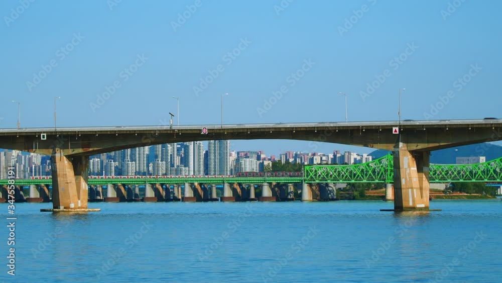 Shot of trains moving through the bridge across Han River in Seoul, South Korea Shot of trains moving through the bridge across Han River in Seoul, South Korea