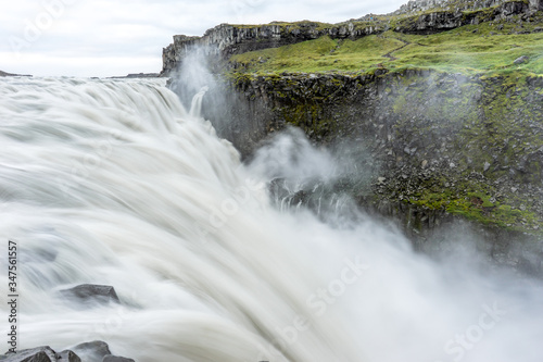 Northern europe most powerful waterfall  the dettifoss in Iceland during early morning hours. Soft light and cloudy sky with big mist swirls. Travelling  holiday and icelandic concept.