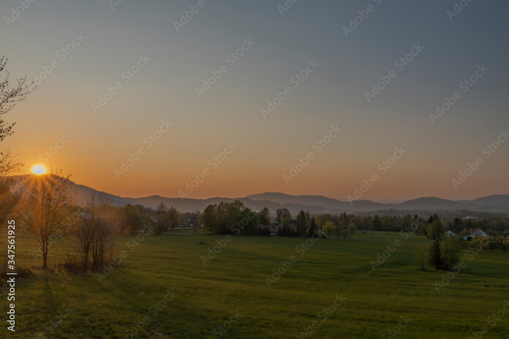 Color sunset with fresh meadows and old buidlings near Trojanovice village