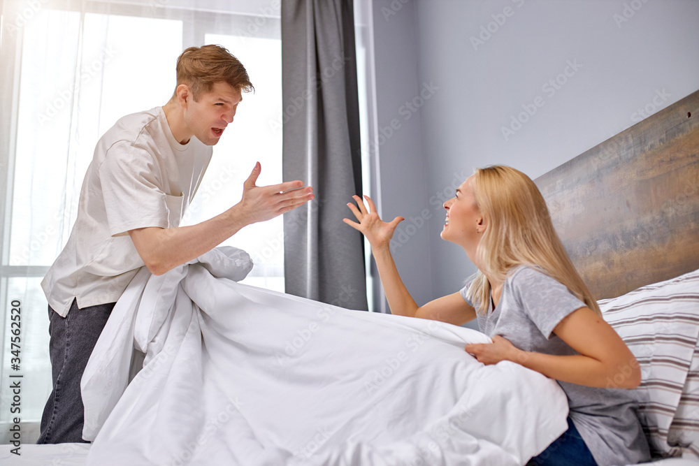 young caucasian husband and wife cannot share the bed, have quarrel in the morning, quarrel from scratch young caucasian husband and wife cannot share the bed, have quarrel in the morning, quarrel from scratch