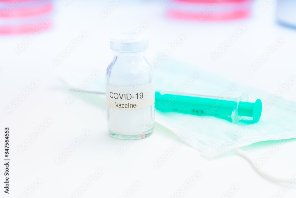 Nobel coronavirus covid-19 vaccine vial, in a biological laboratory with a biological tube for analysis and sampling of Covid-19 infectious disease. Nobel coronavirus covid-19 vaccine vial, in a biological laboratory with a biological tube for analysis and sampling of Covid-19 infectious disease.