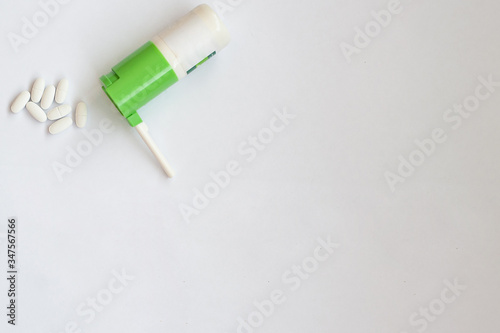 pills and throat spray on a white background