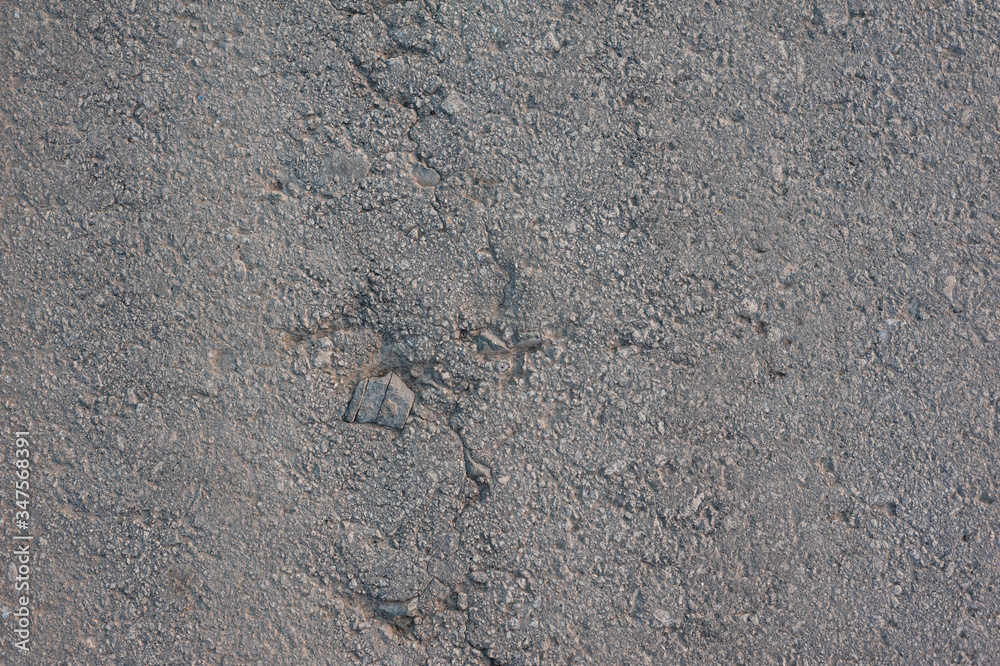 texture of old gray asphalt with a crack