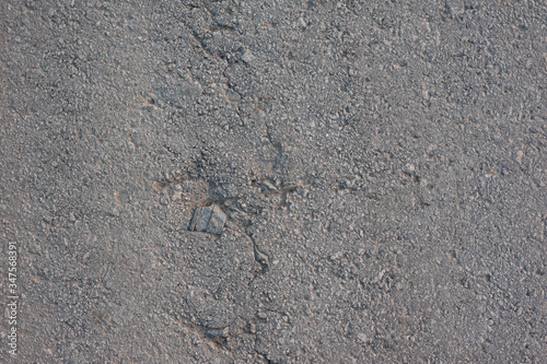 texture of old gray asphalt with a crack
