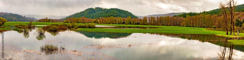 Panorama of lake with forest, mountains and clouds Panorama of lake with forest, mountains and clouds