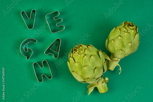 green artichokes on color background photo