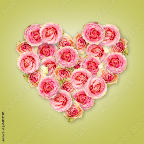 Bouquet of tea roses in the shape of a heart on a light green background. Valentine s Day.