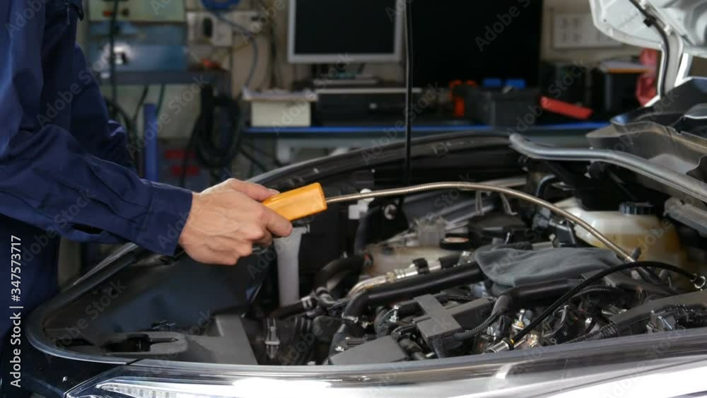 mechanic hand check for leaks in GAS LPG gasoline in a car mechanic hand check for leaks in GAS LPG gasoline in a car