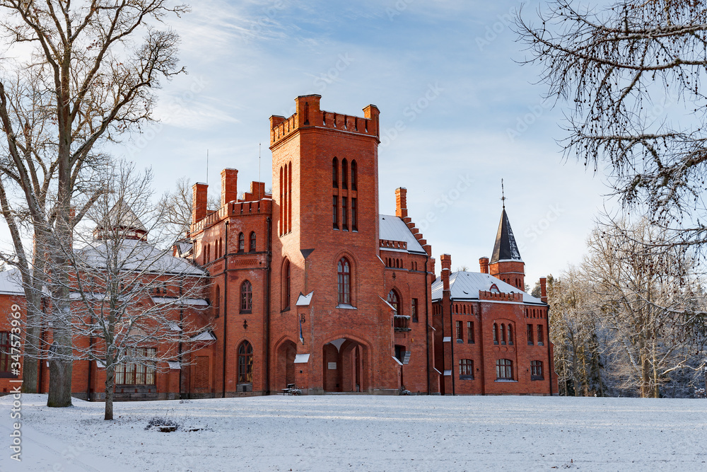Red brick Sangaste castle in Estonia inspired by Windsor Castle in England. Winter time.