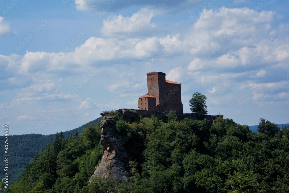Trifels castle on mountain top with clouds and blue sky Trifels castle on mountain top with clouds and blue sky