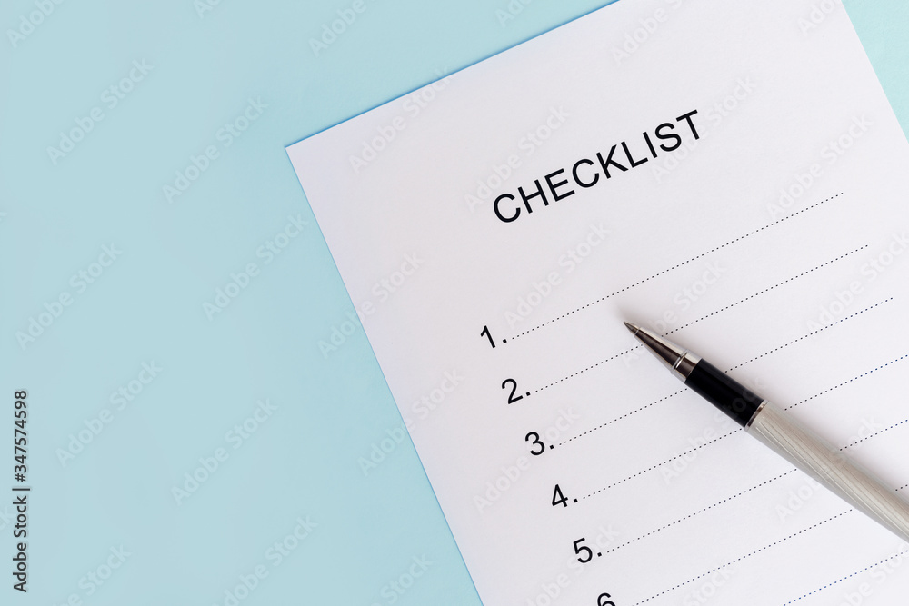 Close-up of on Checklist with pen on a blue background. Close-up of on Checklist with pen on a blue background.