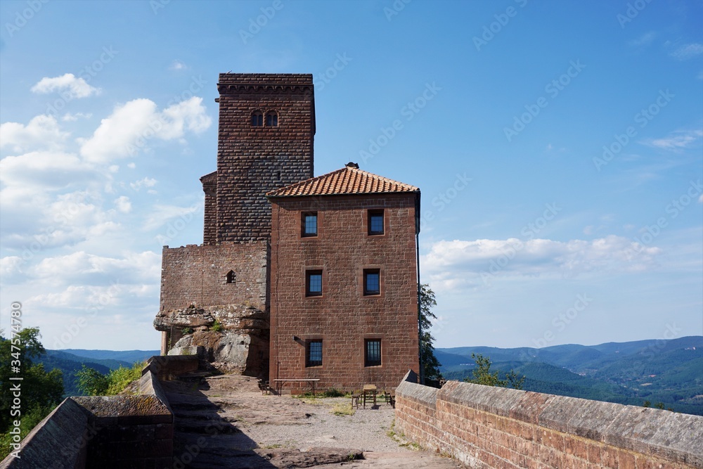 Medieval Trifels castle in front of blue sky and white clouds