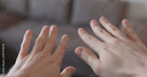 pov shot of man showing clean hands after applying sanitizer gel to his hands closeup