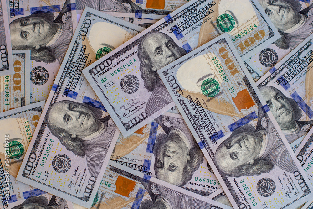 Many one hundred US dollars bills on flat background surface close up. Flat lay top view Many one hundred US dollars bills on flat background surface close up. Flat lay top view