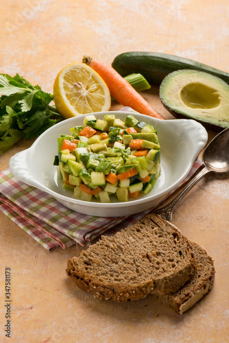 tartar salad with avocado carrots zucchinis and celery