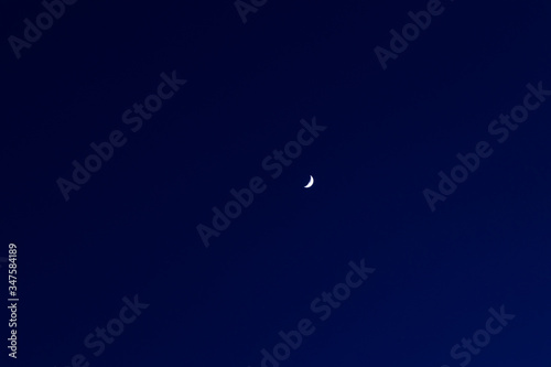 soft focus moon on dark blue night sky background long exposure nature photography with empty copy space for your text