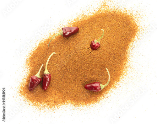 Dried ground powder red chili peppers or cayenne chili peppers on a white plate cutout photo