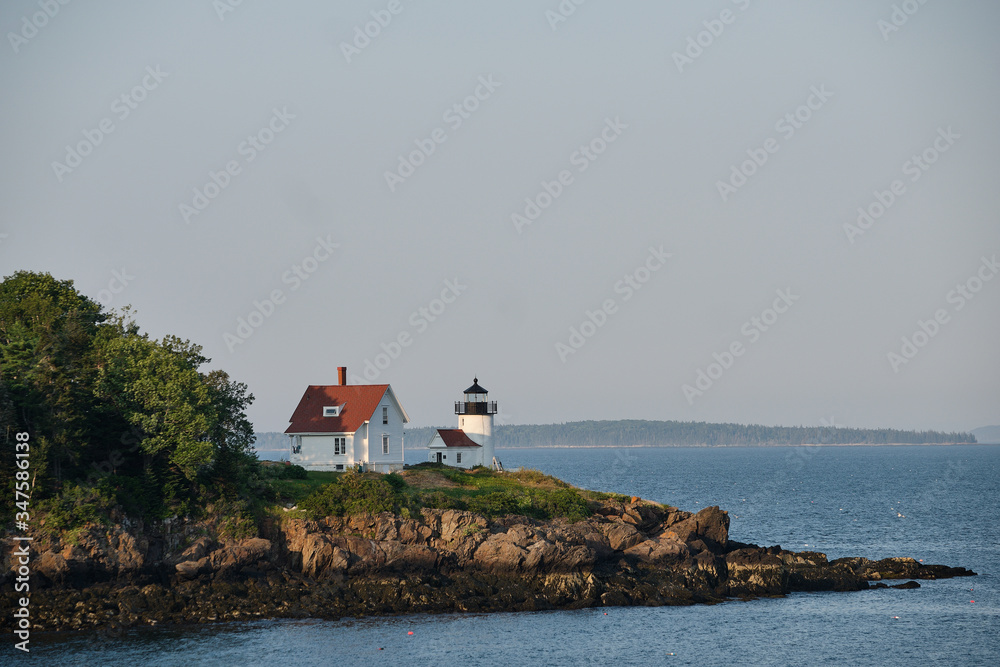The very picturesque Curtis Island Lighthouse on the rocky shores at the entrance to Camden Harbor in Maine