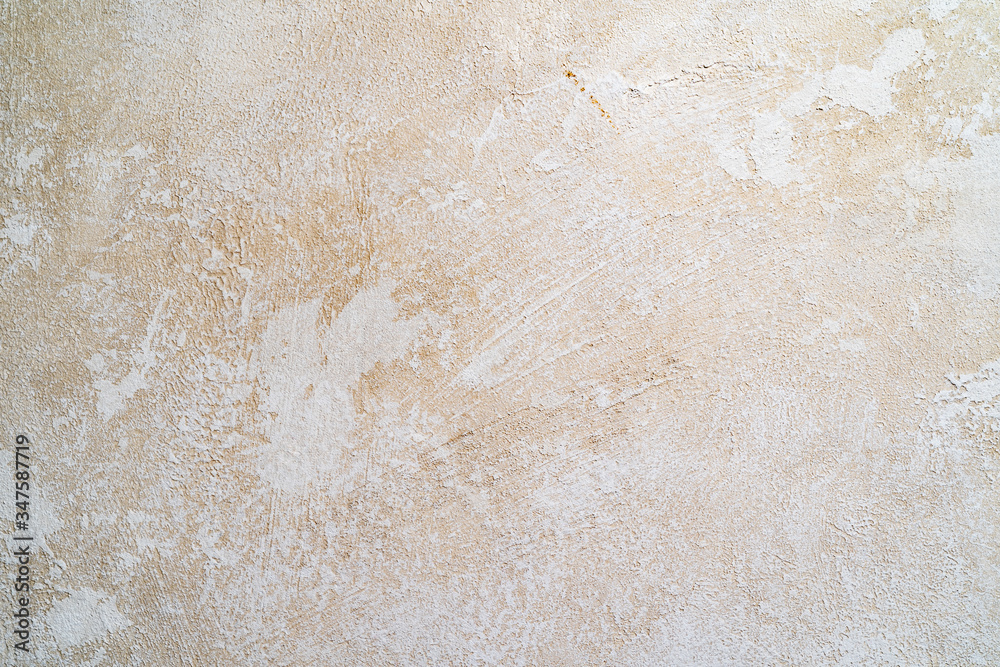 Light beige texture of the wall with scuffs and smears of plaster. Background Light beige texture of the wall with scuffs and smears of plaster. Background