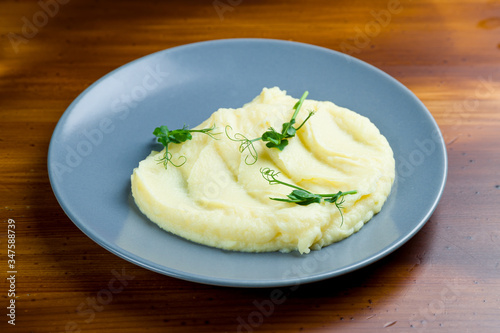 mashed potatoes on bowl on wooden table