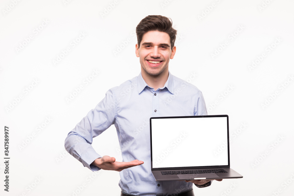 Business man pointing at a laptop isolated on white background Business man pointing at a laptop isolated on white background