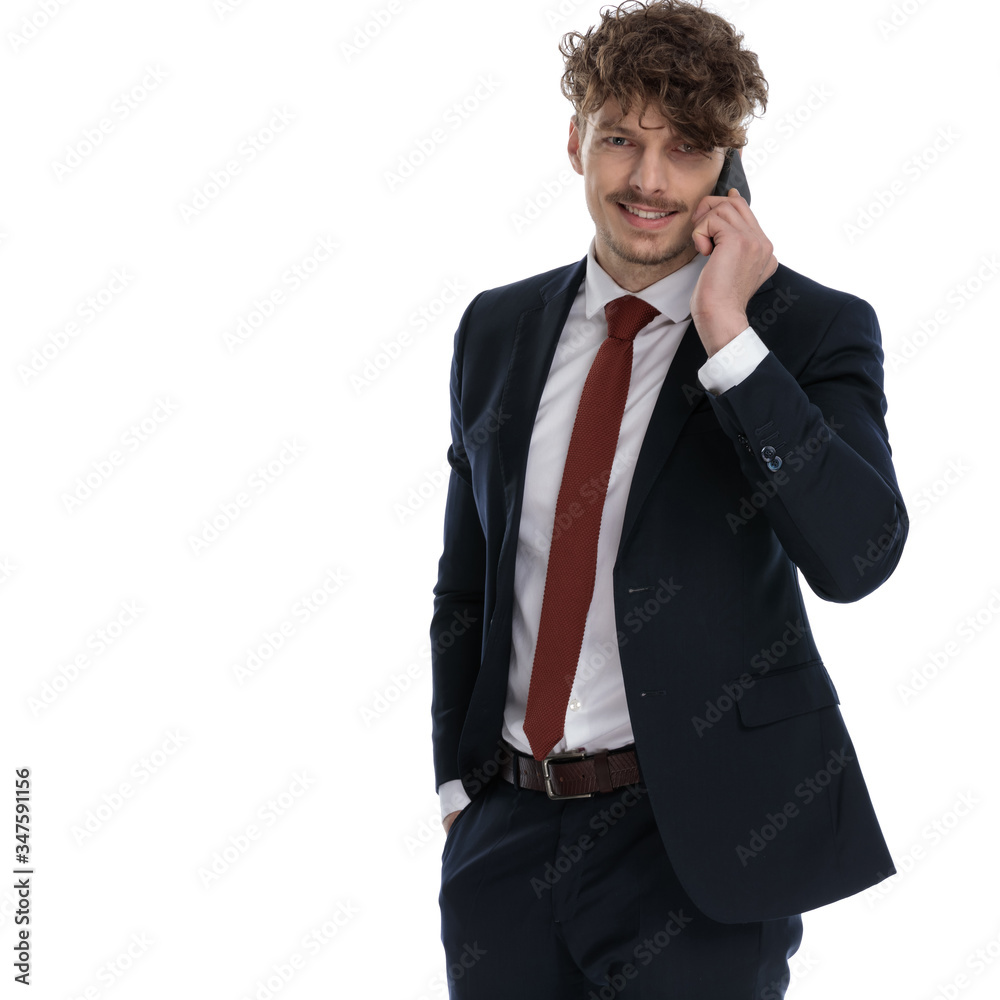 Positive businessman talking on phone and smiling Positive businessman talking on phone and smiling