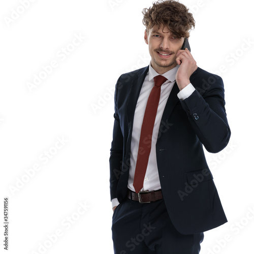 Positive businessman talking on phone and smiling
