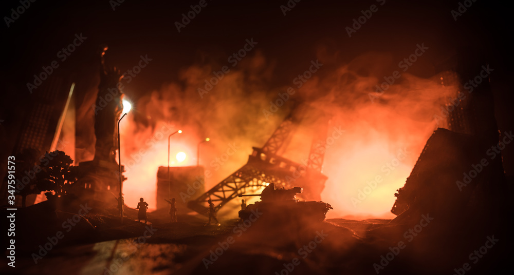 Empty street of burnt up city, flames on the ground and blasts with smoke in the distance. Apocalyptic view of city downtown as disaster film poster concept. Night scene. City destroyed by war.