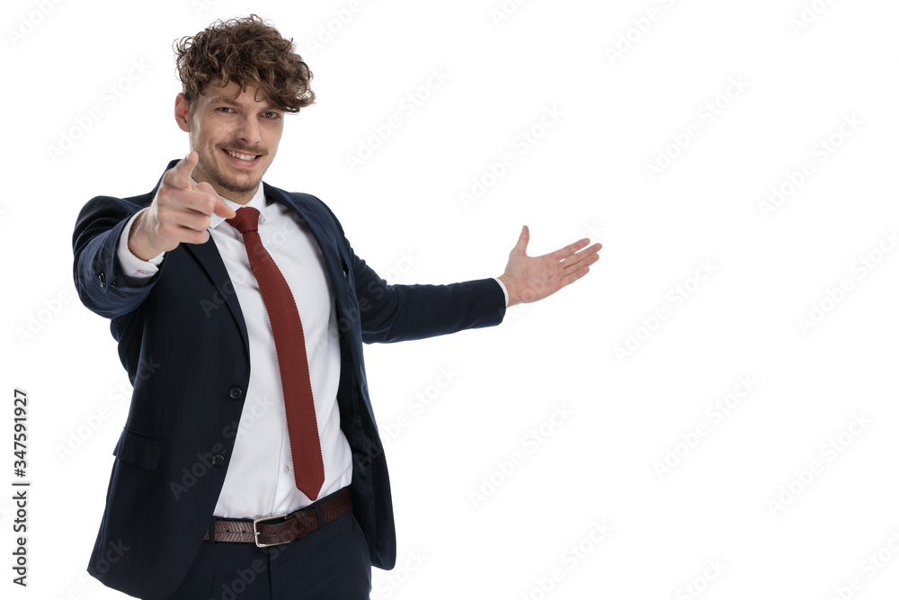 Happy businessman smiling, pointing and presenting Happy businessman smiling, pointing and presenting
