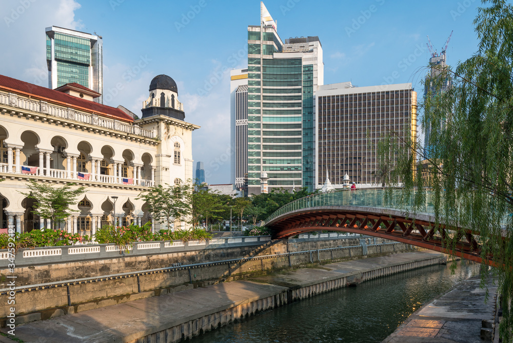 Modern pedestrian bridge overcrossing the Gombak river at Ministry of Tourism and Culture in Kuala Lumpur, the capital of Malaysia