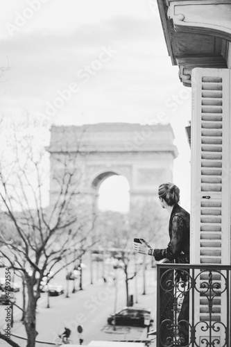 Photography Attractive  yang woman in pajama is drinking coffee on balcony in the morning in city Paris