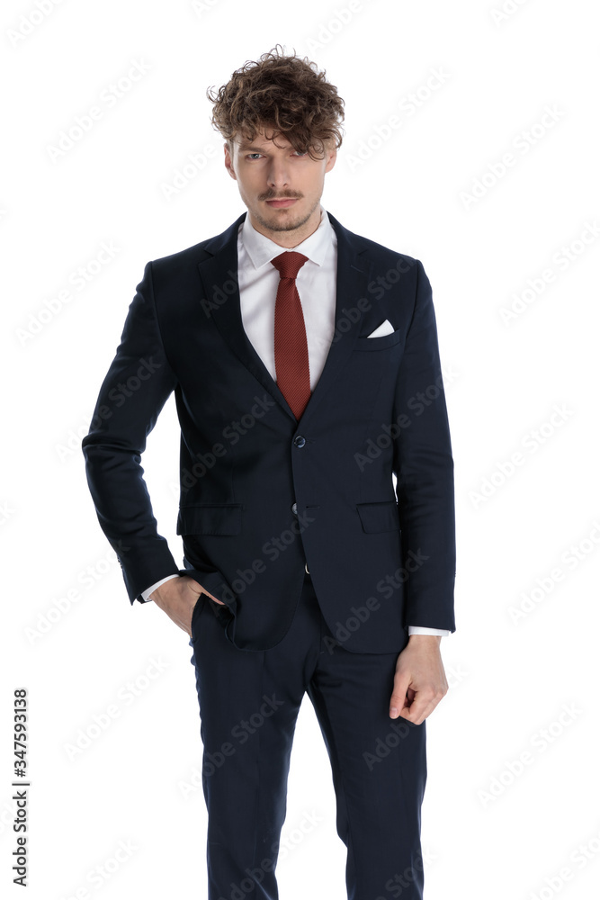 Bothered businessman frowning with hand in pocket Bothered businessman frowning with hand in pocket
