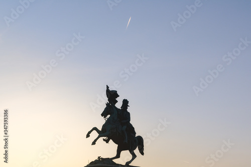Silhouette of equestrian statue of Archduke Charles in front of Hofburg Palace in Vienna, Austria
