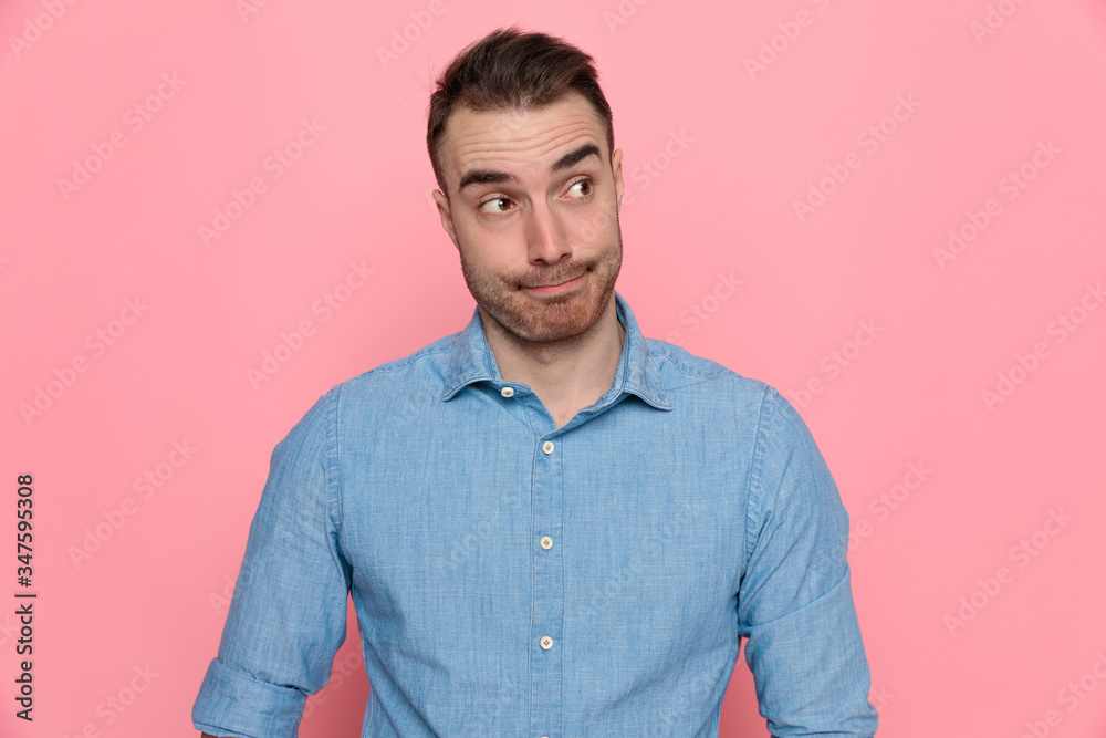 casual man looking aside, wearing a blue shirt casual man looking aside, wearing a blue shirt