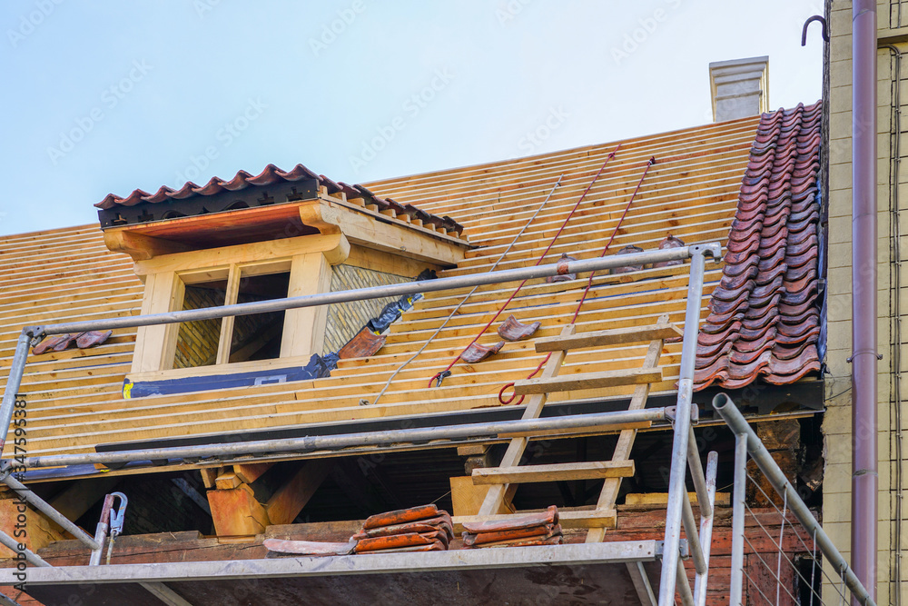 repair of the roof structures of a historic wooden house and replacement of clay tiles repair of the roof structures of a historic wooden house and replacement of clay tiles