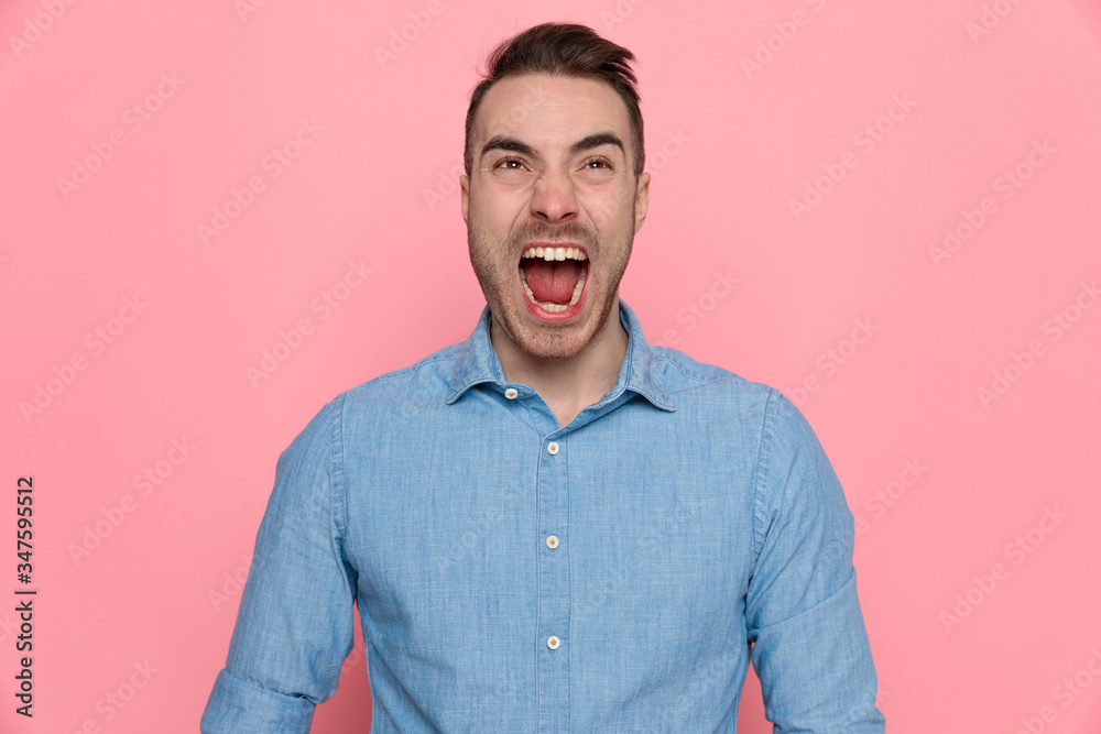 young angry casual man is screaming out loud young angry casual man is screaming out loud