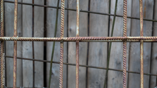 Metal reinforcement bars on a wooden background. Building structure.